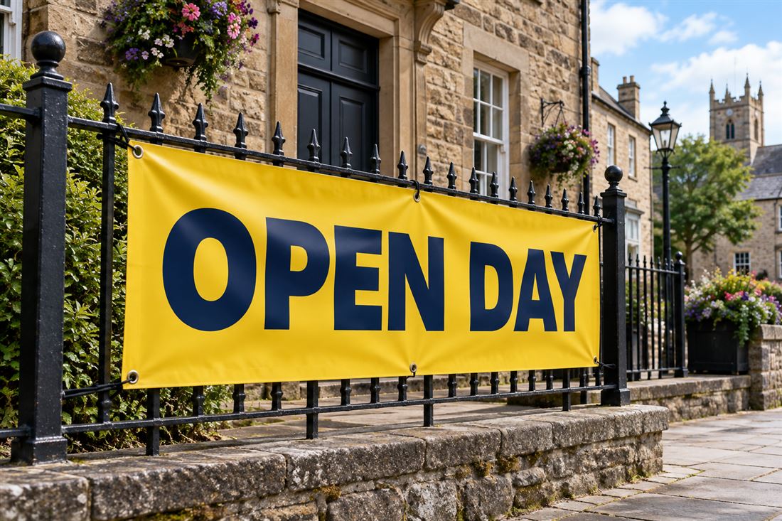 Yellow banner with bold navy lettering on railings