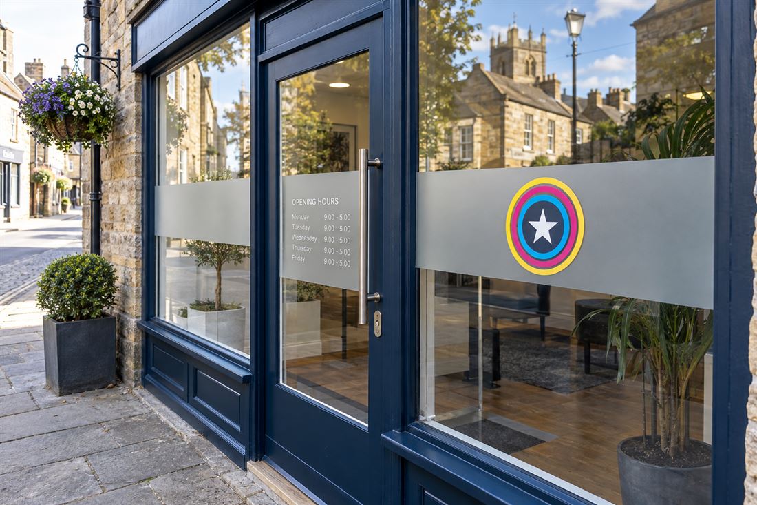 Frosted vinyl band with logo across a shop window and door